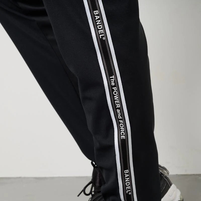 BANDEL GOLF コンセプトノーツテーピングテーパードパンツ BLACK